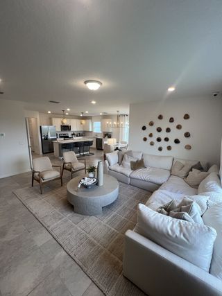 Model Home Bright and spacious living room with contemporary furnishings, natural light, and a cozy ambiance.