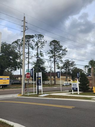 Street view A peaceful street scene with signage in Wyndbrook by D.R. Horton, located in Jacksonville, FL.