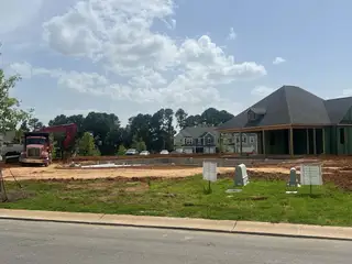 A charming under-construction home in Piper Landing by M/I Homes, Concord, NC, surrounded by lush greenery and new builds.