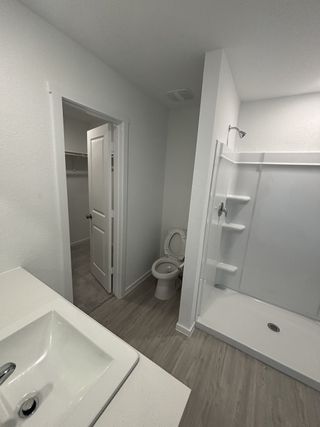 A modern bathroom featuring a sleek vanity, spacious walk-in shower, and a neutral color palette for a clean look.