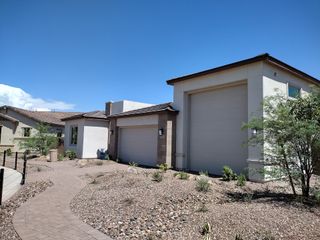 A modern home with sleek lines and desert landscaping in Artisan at Asante by Pulte Homes (Surprise, AZ).