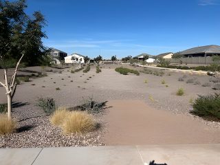 A tranquil desert landscape with modern homes in Estrella Crossing by Starlight Homes (Laveen, AZ).