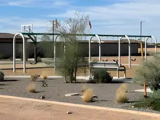 A scenic playground with swings and desert landscaping in The Ridge Collection at North Copper Canyon by Century Communities (Surprise, AZ).