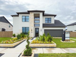 Street view A modern home with stone accents and vibrant landscaping in Grange 55' by Westin Homes (Katy, TX).
