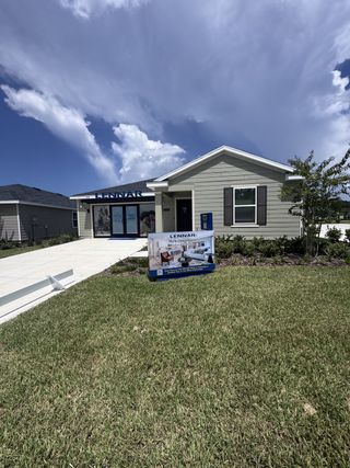 A charming single-story home with a neat lawn in Holstein Crossing: Holstein Crossing 50s by Lennar (Green Cove Springs, FL).