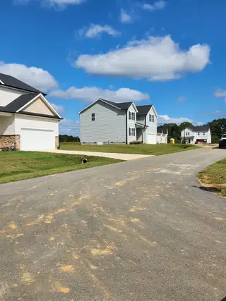 Street view Modern homes on a quiet street in Hawthorne West by Lennar, offering serene living in Zebulon, NC.