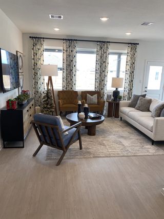 A cozy living room with stylish furniture, patterned curtains, and soft lighting, creating an inviting atmosphere.