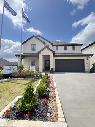 Elegant brick home with manicured landscaping in Tesoro at Chisholm Trail Ranch by Meritage Homes (Crowley, TX).