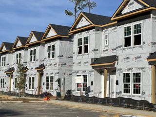 Street view Newly constructed townhomes in Twin Rivers Towns by Prosperity Builders, Charleston, SC, featuring modern design elements.