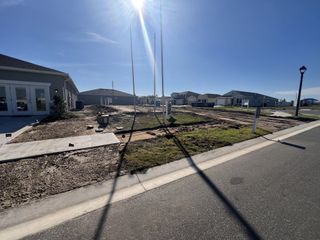 New construction homes and a manicured community layout in Seasons at Heritage Square by Richmond American Homes (Haines City, FL).