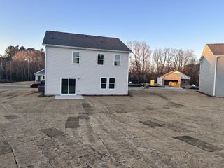 A modern beige home with a spacious backyard in Green Hill by Starlight Homes (Louisburg, NC).