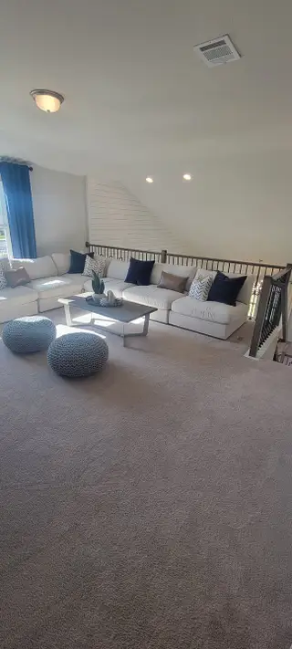 A cozy and well-appointed loft area with comfortable seating, creating a perfect spot for relaxation or family gatherings.