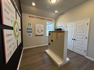 A modern room showcasing energy-efficient construction materials and informative displays.