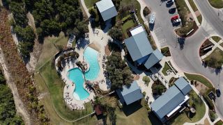 Charming aerial view of community amenities, featuring a stylish pool area in Headwaters 50' - Executive Series by David Weekley Homes (Dripping Springs, TX).
