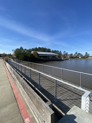 A scenic lakeside walkway with serene views in ARTAVIA® - 60' by Westin Homes, Conroe, TX.