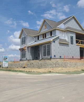A modern two-story home under construction in The Grove Frisco by Chesmar Homes in Frisco, TX.
