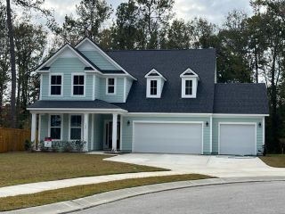A charming blue two-story home with a spacious yard in Enclave at South Pointe Estates by DRB Homes (Summerville, SC).