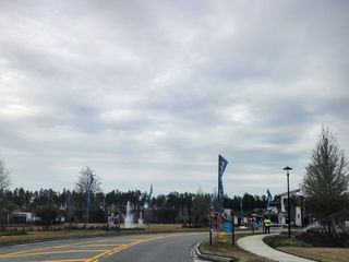 A welcoming entrance with scenic surroundings in Del Webb Wildlight by Del Webb, Wildlight, FL.