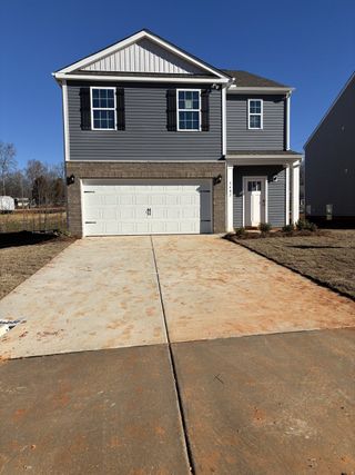 A charming gray two-story home with a white garage and shutters in Cramer Estates by D.R. Horton (Gastonia, NC).