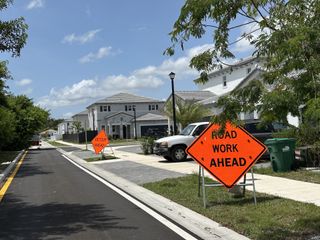 Beautiful modern homes on a sunny day, amidst road work in Salerno by Lennar in Richmond West, FL.