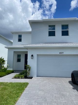 A modern white home with a sleek design in Symphony Place by Mizner Development, West Palm Beach, FL.