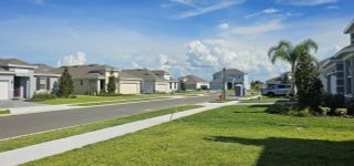 A well-manicured neighborhood with elegant single-family homes and scenic sidewalks in Leela Reserve by Park Square Residential (Tavares, FL).