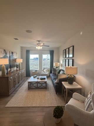 A cozy living room featuring a plush sofa, modern armchairs, and a rustic coffee table with elegant decor pieces.