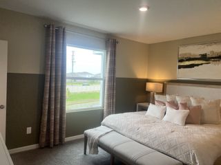 A cozy bedroom featuring a plush bed with soft pillows, stylish curtains, and calming artwork for a serene atmosphere.