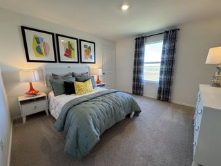 A cozy bedroom with abstract art, colorful pillows, and soft lighting, creating a welcoming atmosphere.