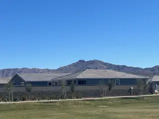 A modern home set against mountain views in the Estates at Estrella Crossing by Ashton Woods (Phoenix, AZ).