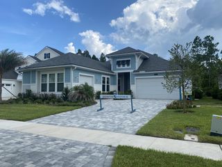 Street view A charming home with a manicured lawn and modern design in Reflections and Seabrook at Nocatee by Dostie Homes (Ponte Vedra Beach, FL).