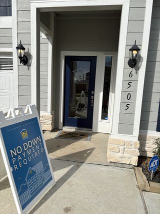Charming entry with modern lighting in Park Vista at El Tesoro by LGI Homes, offering no down payment options (Houston, TX).