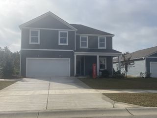 A charming modern home with a spacious garage and inviting porch in Bradford Pointe by Centex, Summerville, SC.