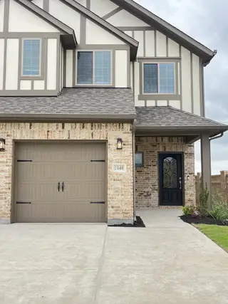 A charming brick and stucco home with elegant trim in Elevon by Pacesetter Homes, Lavon, TX.