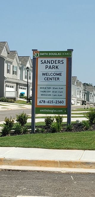 Street view Charming homes in Sanders Park by Smith Douglas Homes, Austell, GA, with manicured lawns and welcoming streetscapes.