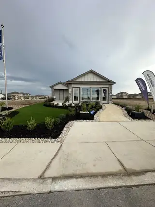 Charming contemporary home with a manicured lawn in Preserve at Medina by D.R. Horton (Von Ormy, TX).