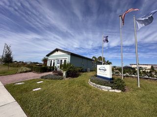 Street view A welcoming model home with landscaped gardens in Lake Deer Estates - Classic Series by Meritage Homes (Poinciana, FL).