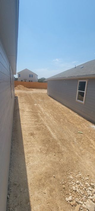 Street view A spacious lot with future potential in Landon Ridge by Lennar, San Antonio, TX, ready for landscaping possibilities.