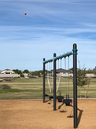 A scenic community playground with swings in Edgewood Estates by K. Hovnanian® Homes, Queen Creek, AZ.