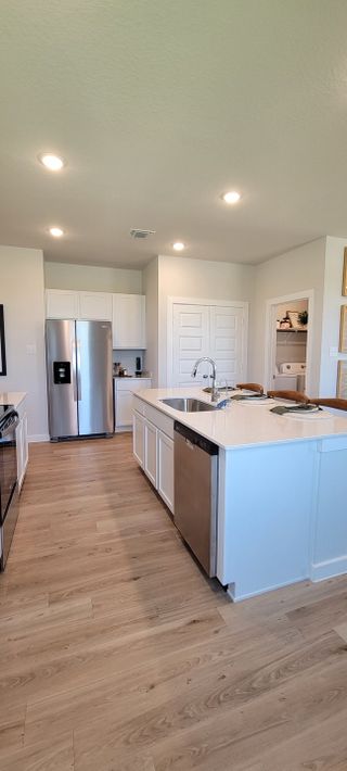 A bright and airy kitchen with wood flooring, quartz countertops, and an open layout perfect for entertaining.