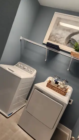 A serene corner with two accent chairs, plaid drapes, and abundant natural light, offering a peaceful retreat.