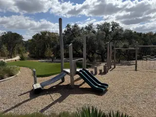 Community Amenities A serene playground with natural elements in Wolf Ranch: 46ft. lots by Highland Homes, Georgetown, TX.