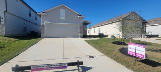 A contemporary home with a spacious driveway in Millican Grove by Legend Homes, San Antonio, TX.