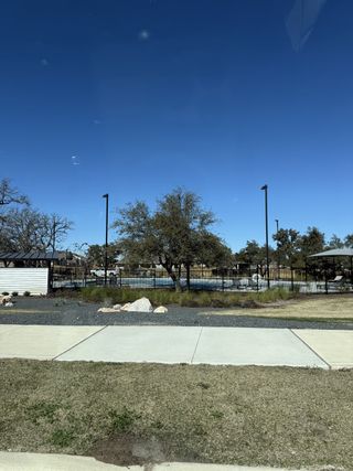 A landscaped community park with a pool in Rosenbusch Ranch by D.R. Horton (Leander, TX).