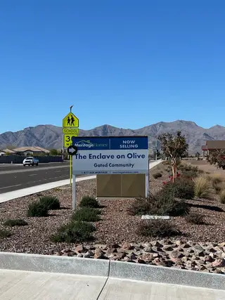 A scenic entry to The Enclave on Olive by Meritage Homes with mountain views in Waddell, AZ.