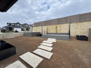 Model Home Modern exteriors with stone accents and neat pathways in Easton Park 40' by Perry Homes (Austin, TX).