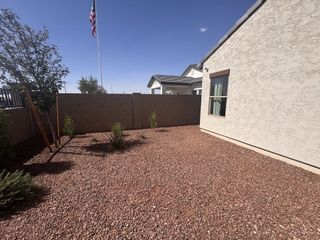 A beautifully landscaped yard with desert plants and gravel in Monroe Ranch by K. Hovnanian® Homes (Buckeye, AZ).