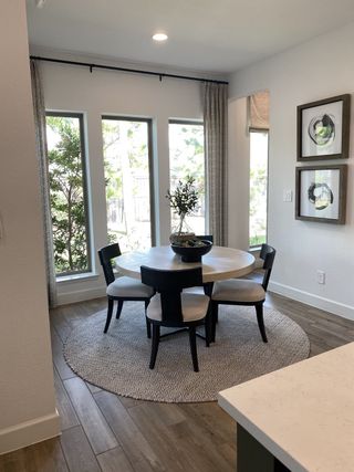A charming breakfast nook with a round dining table, large windows, and abundant natural light.