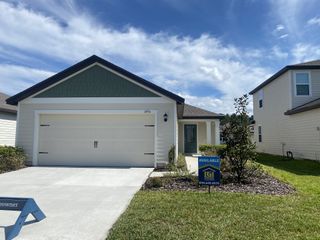 Street view A charming single-story home with green accents in Westport Landing by LGI Homes, Jacksonville, FL.