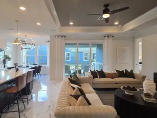 An open-concept living space with plush seating, a sleek kitchen island, and stylish black and gold accents.